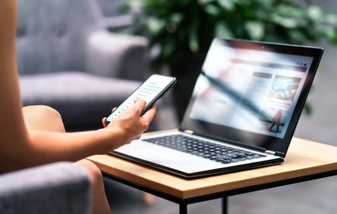 Wireless wifi for remote work in airport lounge bar, hotel lobby or cafe. Phone and laptop. Woman using smartphone and modern notebook pc computer on table. Real estate agent or student reading email